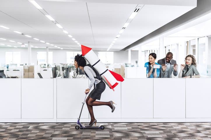 A career oriented moving on skaters with a rocket on her back in office