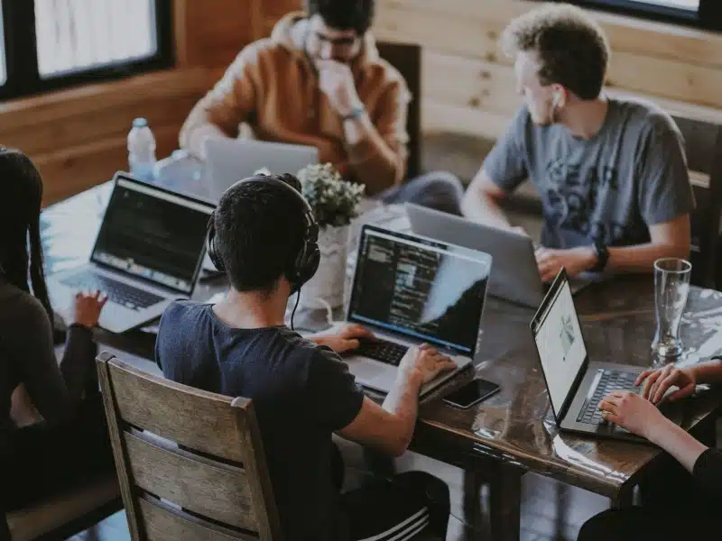 A Business Development Intern working with teammate on a shared desk