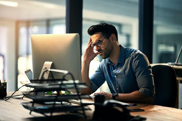 An employee stressed out and demotivated by his work