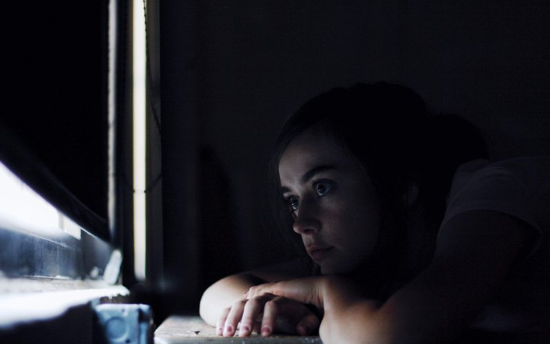 A woman wide awake at night sitting alone