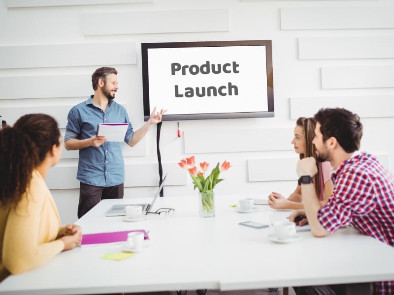 A Product Specialist presenting a product launch using a whiteboard