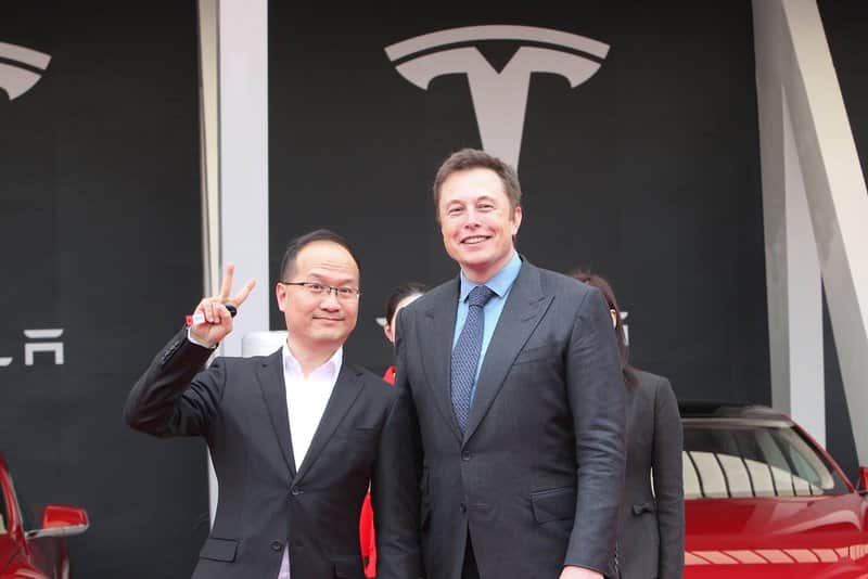 --FILE--Tesla CEO Elon Musk, right, is pictured during a delivery ceremony at the sales center of Tesla in Jinqiao, Shanghai, China, 23 April 2014.

Tesla CEO Elon Musk and the electric car company have agreed to pay a total of  million and make a series of concessions to settle a government lawsuit alleging Musk duped investors with misleading statements about a proposed buyout of the company. Tesla and Musk will each pay m to settle the case. The settlement will require Musk to relinquish his role as chairman for at least three years, but he will able to remain as CEO. The Securities and Exchange Commission announced the settlement Saturday, just two days after filing a case seeking to oust Musk as CEO. *** Local Caption *** 
