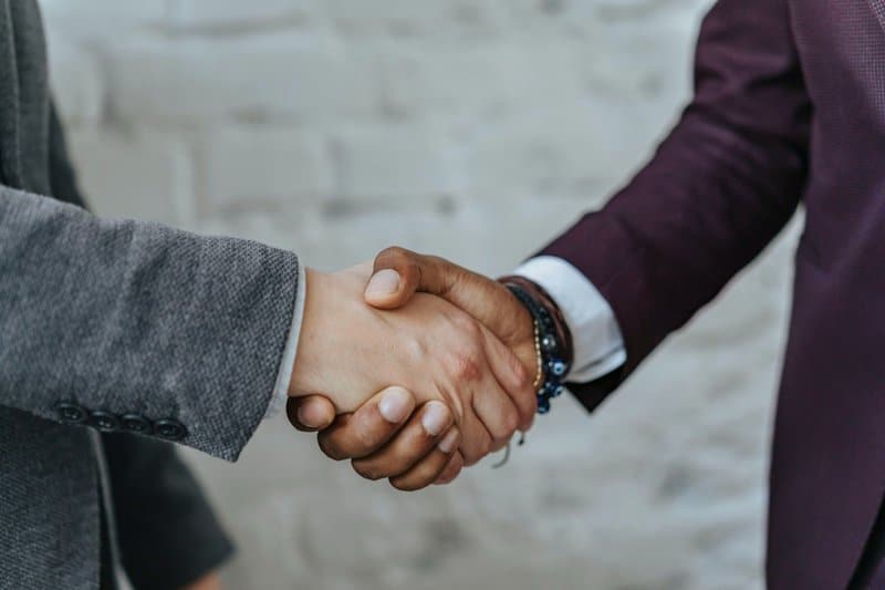 a hand shaking representing a way to thank your employee he has done a great job