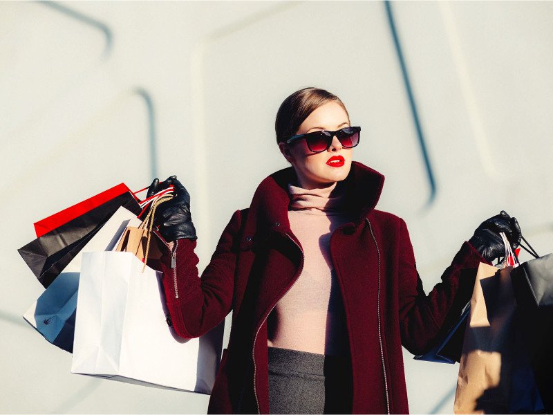 A fashion women holding bags illustrating fashion marketing articles
