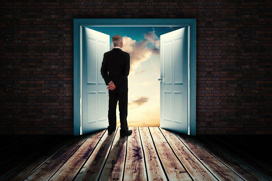 Man looking at an open door in the sky, representing his mind and the his thoughts during an intrapersonal communication