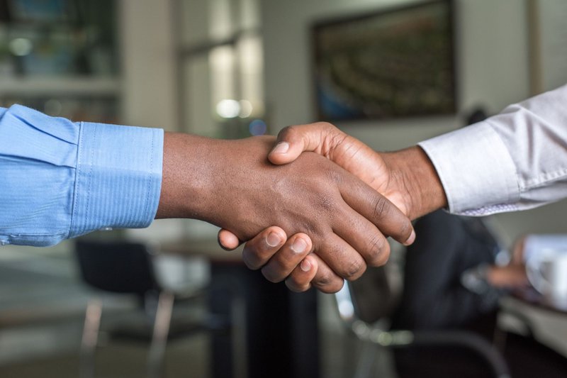 Two people shaking hands representing a successful negotiation
